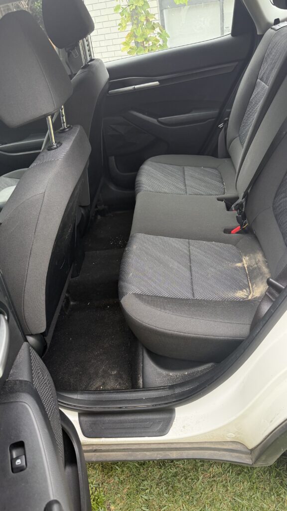 Kia interior photographed before detailing.