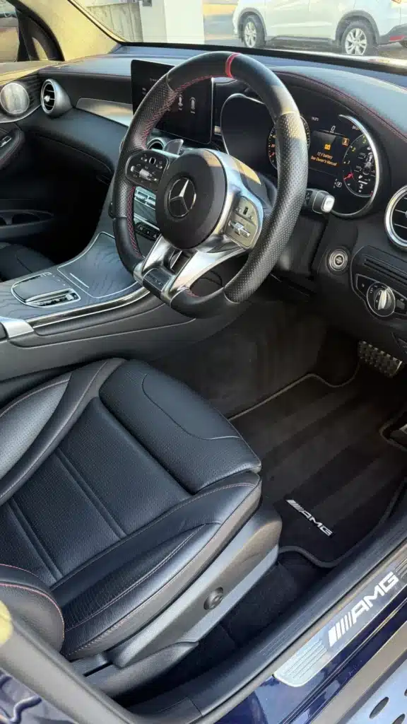 Clean black Mercedes driver seat and cabin after a full detail.