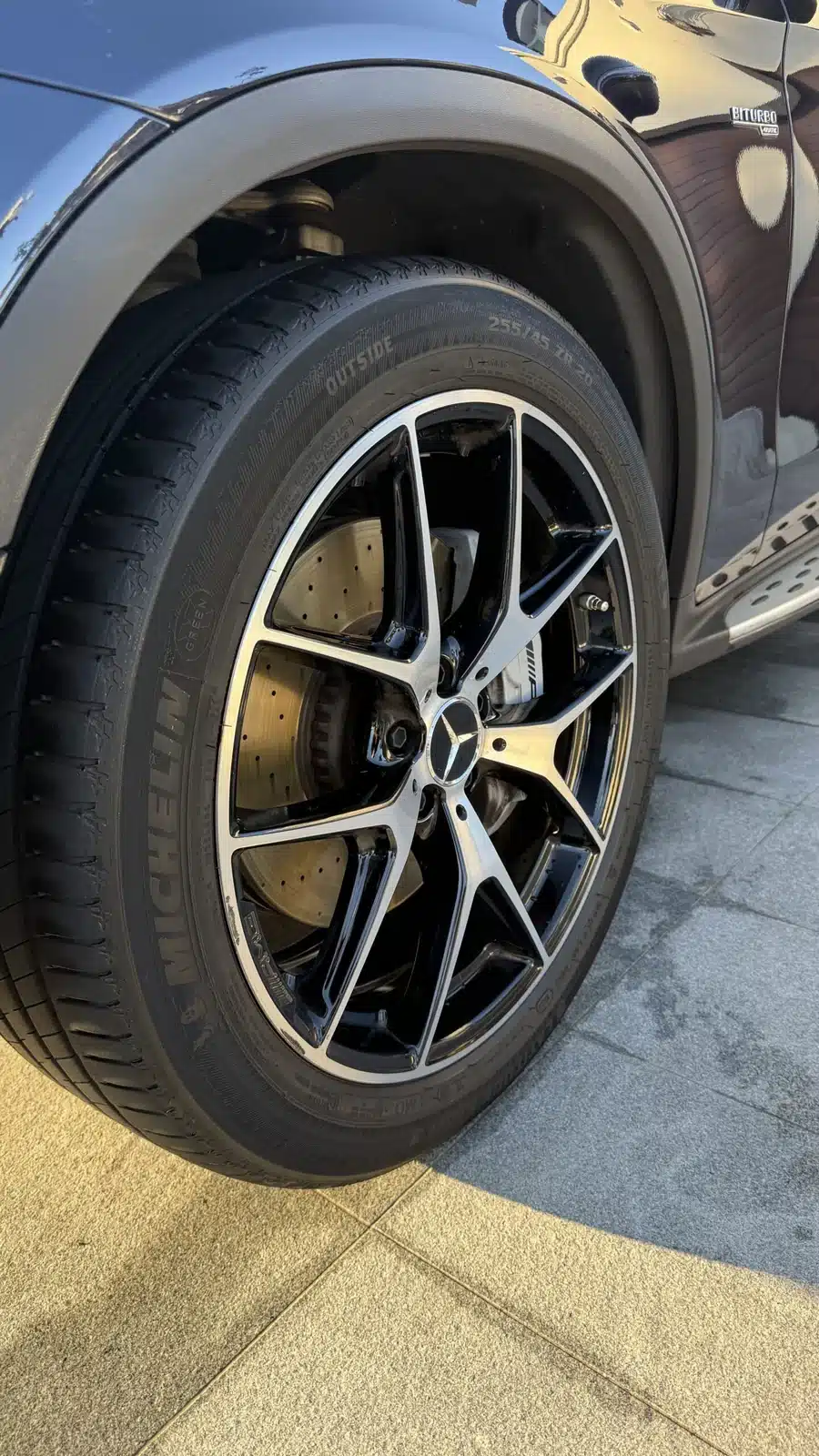 Clean Mercedes alloy wheel and reflective black bodywork after a full detail.