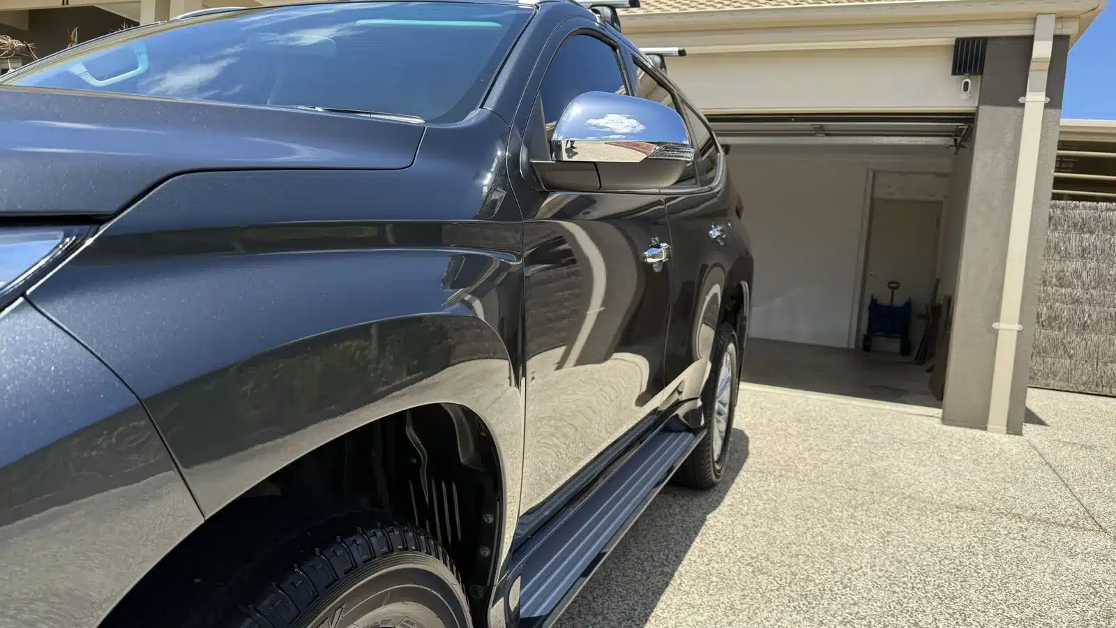 Mitsubishi Pajero wheel, front wing and reflective doors after paint correction.